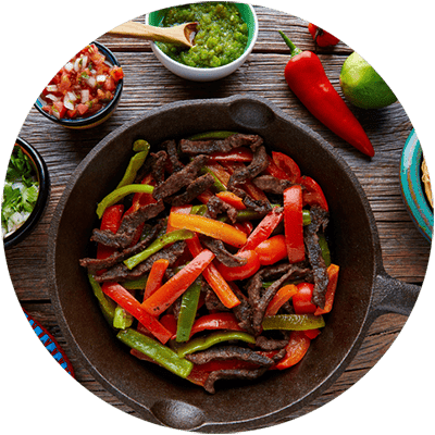 A plate of food with a piece of meat and vegetables.