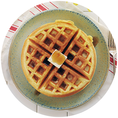a plate of waffles with a pat of butter on top