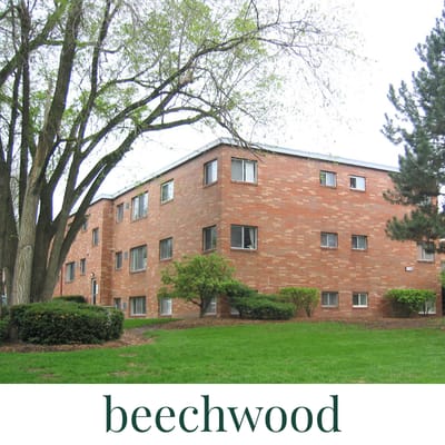 A brick building with trees in front of it.