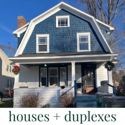 A blue house with white trim and a porch.