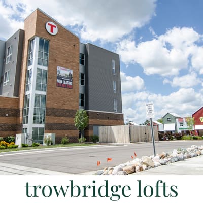 A large brick building with a sign that says "trowbridge lofts".