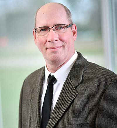a man wearing glasses and a suit and tie