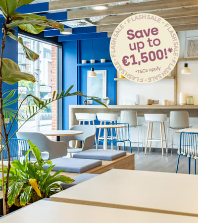 A sign in a room with a table and chairs advertises saving money.
