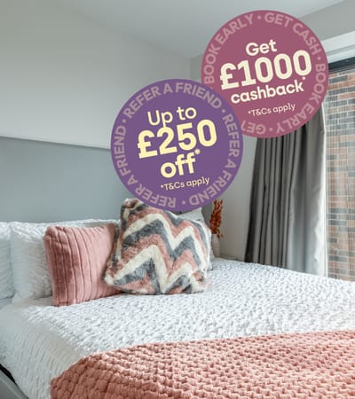 A bedroom with a bed and a sign offering cashback on kitchen and bedding purchases.