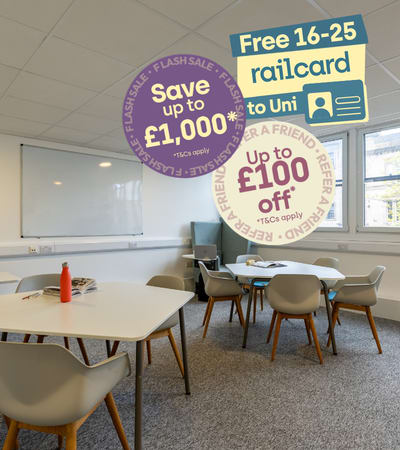 A white table with chairs and a sign offering a free railcard to university students.
