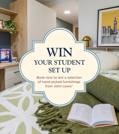 A sign welcoming students from September 2026 is displayed in a room with a sofa and plants.