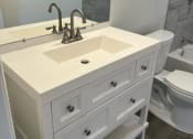 Thumbnail 7 of 11 - a bathroom with a white sink and a toilet
