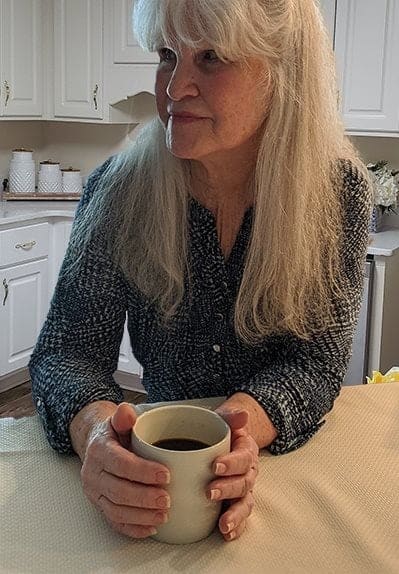 senior resident holding a cup of coffee at Savannah Court of Camilla, Camilla, GA, 31730