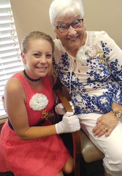 a woman sitting in a chair with an elderly woman at Savannah Grand of Sarasota, Sarasota, FL, 34238