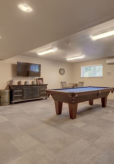 a game room with a pool table and a tv at VINTAGE AT HOLLY VILLAGE SENIORS Apartments, Everett, WA, 98204