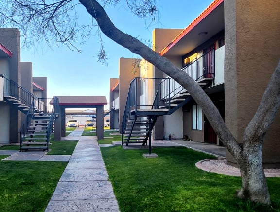 a walkway between two buildings on a sunny day
