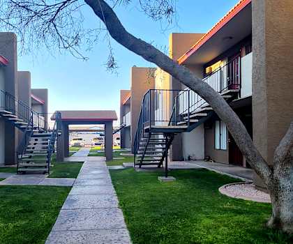 a walkway between two buildings on a sunny day