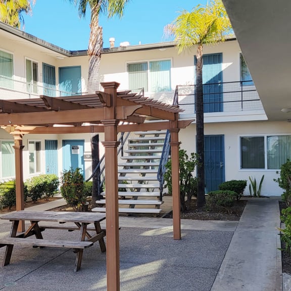 a picnic table in a courtyard with a building in the background