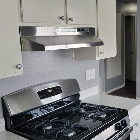 a kitchen in a one bedroom apartment at the historic electric building in fort worth, tx