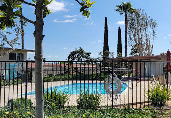 a pool with a black fence in front of it