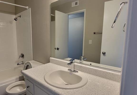 an empty bathroom with a sink and toilet