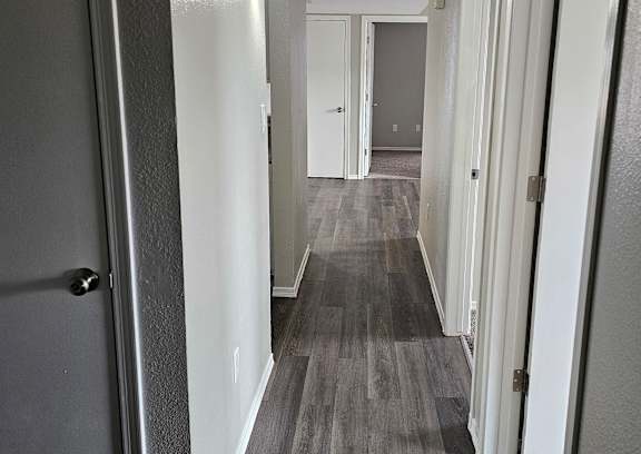 A long hallway with doors on both sides.