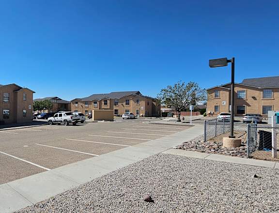 A parking lot with a building in the background.