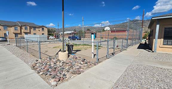 A fenced area with a gravel bed in the middle.