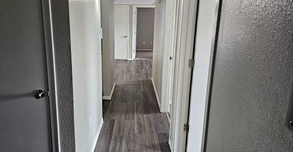 A long hallway with doors on both sides.