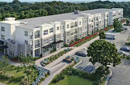 Aerial view of Sage 5430 senior apartments in Norcross, GA with landscaped grounds and parking