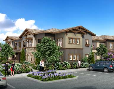 A row of houses with cars parked in front.