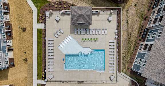 arial view of a pool on the roof of a building