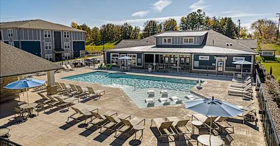 the resort style pool with lounge chairs and umbrellas at the resort at governors