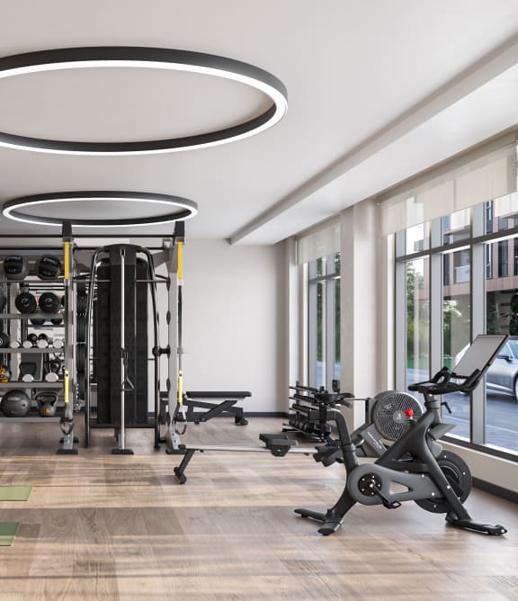 a gym with exercise equipment and a large window