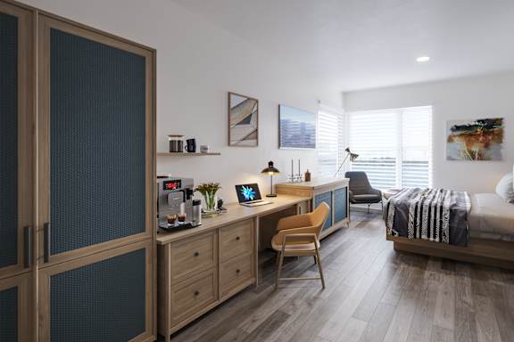 A modern kitchen with a wooden desk and chair.