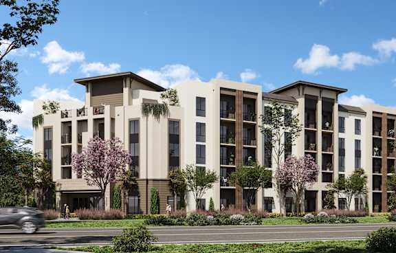 A modern apartment building with a clear blue sky above.