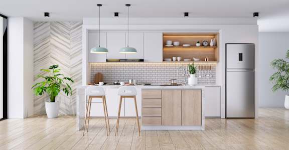 A modern kitchen with wooden floors and a white countertop.