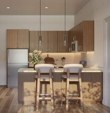 A kitchen with a refrigerator, sink, and bar stools.