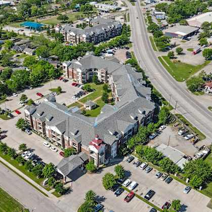 A large building with a parking lot in front of it.
