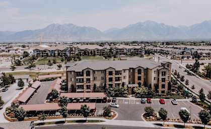 an aerial view of an apartment complex with mountains in the background