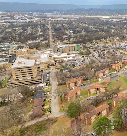 A bird's eye view of a campus with a large building in the center.