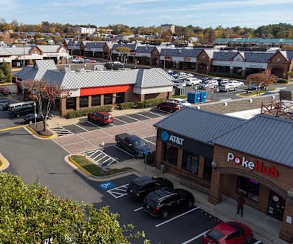 A parking lot with cars and a PokerHub store.