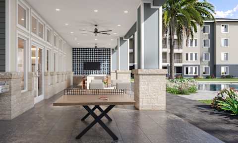 Outdoor Kitchen and Ping Pong Table at Cedar Heights Luxury Apartments in Austin, TX