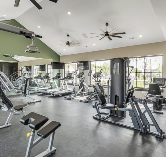 a spacious fitness center with cardio equipment and windows at Slate at Fishers District, Indiana, 46037