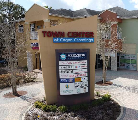 A sign for the Town Center at Cagan Crossings stands in front of a row of buildings.