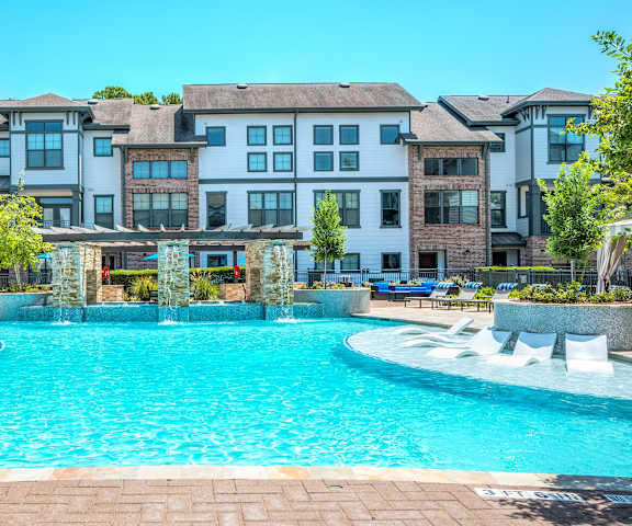 a swimming pool with an apartment building in the background