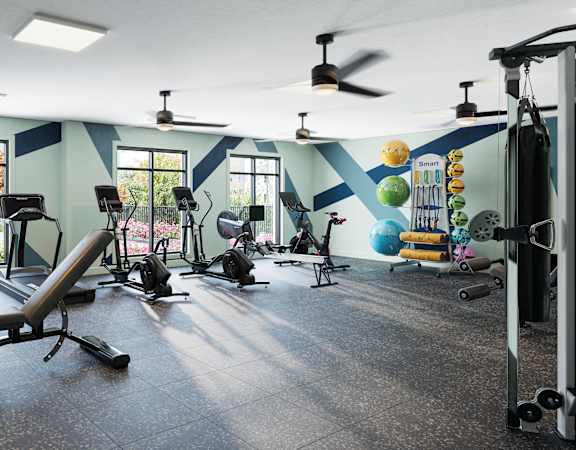 A gym with a variety of equipment including weights and a bench.
