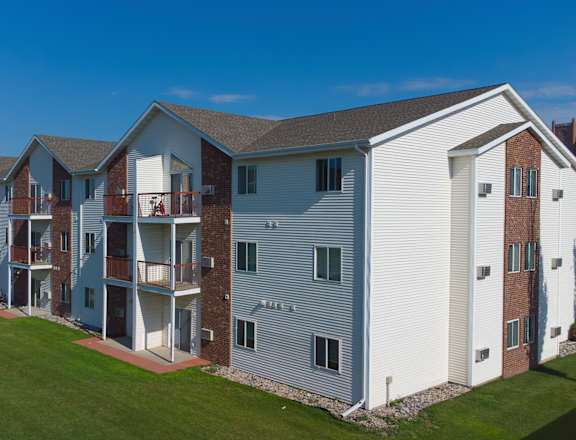 A large apartment complex with multiple buildings and balconies.