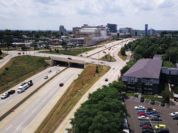 an aerial view of a city with a highway and buildings