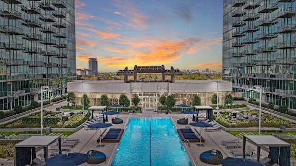 Luxurious swimming pool at Allure Herman with a stunning sunset in the background in Houston, TX