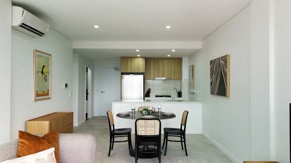 A modern dining room with a table set for two.