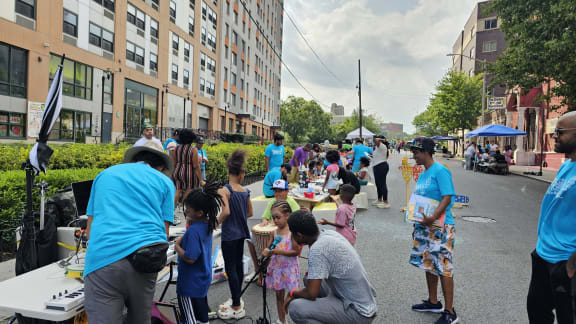 a crowd of people standing around a street fair