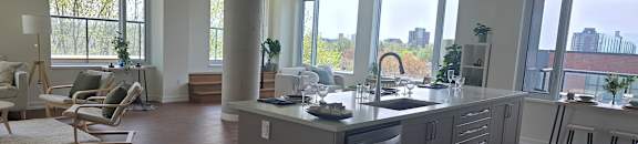 A modern kitchen with a large island and wooden floors.