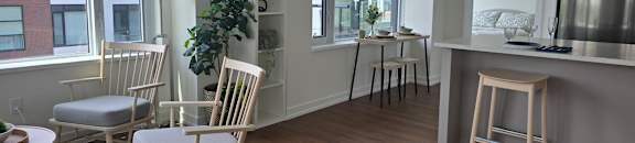 A kitchen with a dining table and chairs.