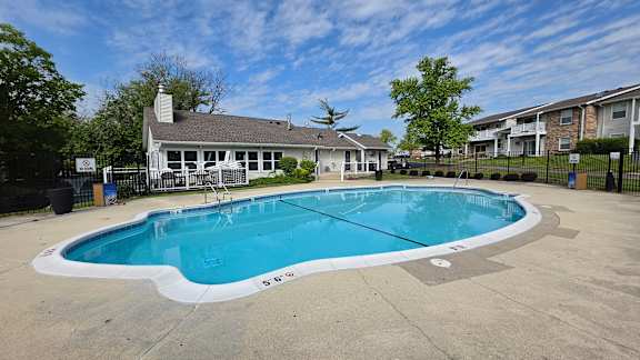A large outdoor swimming pool surrounded by a fence.